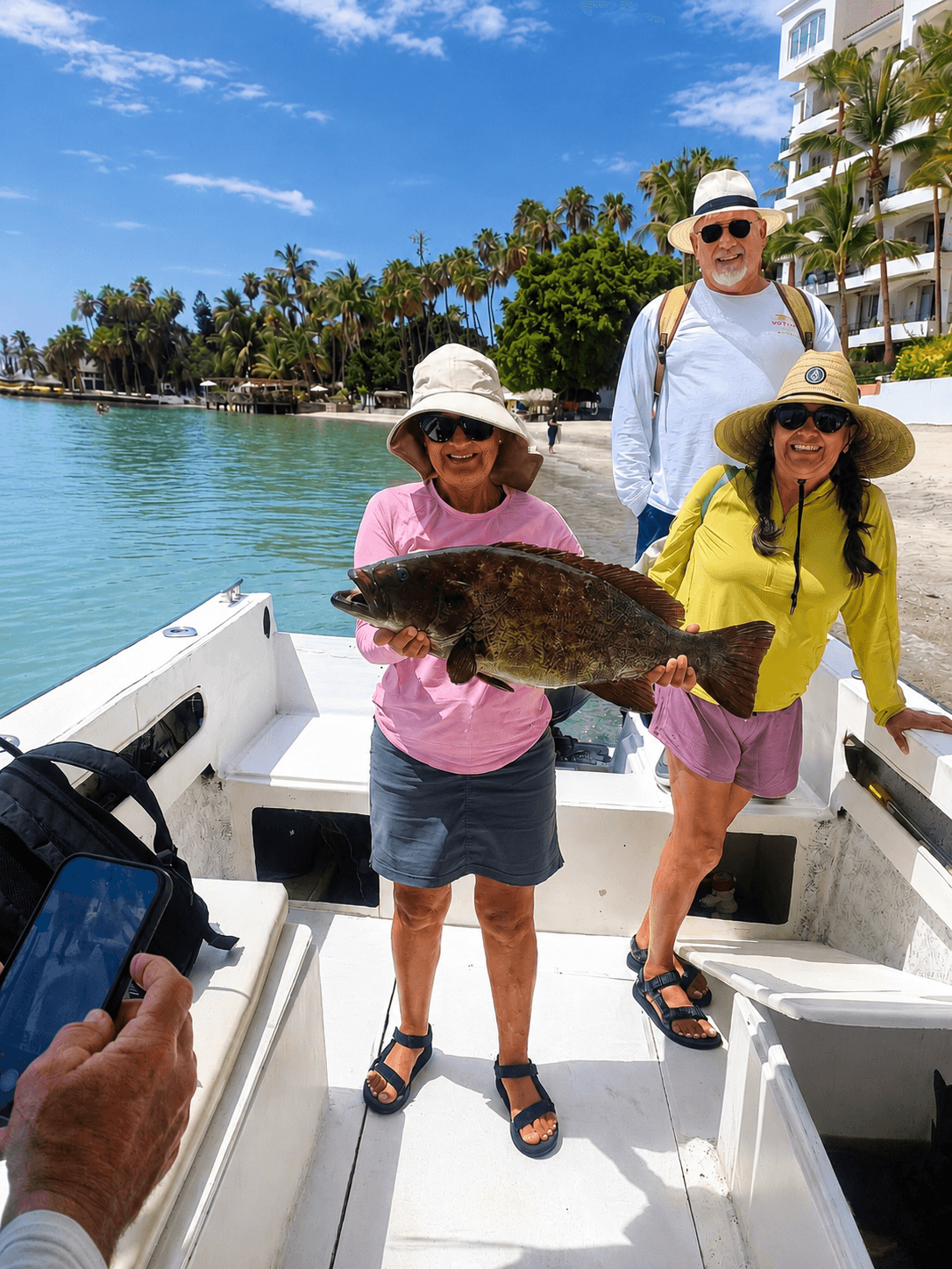 Family with their catch, close to shore